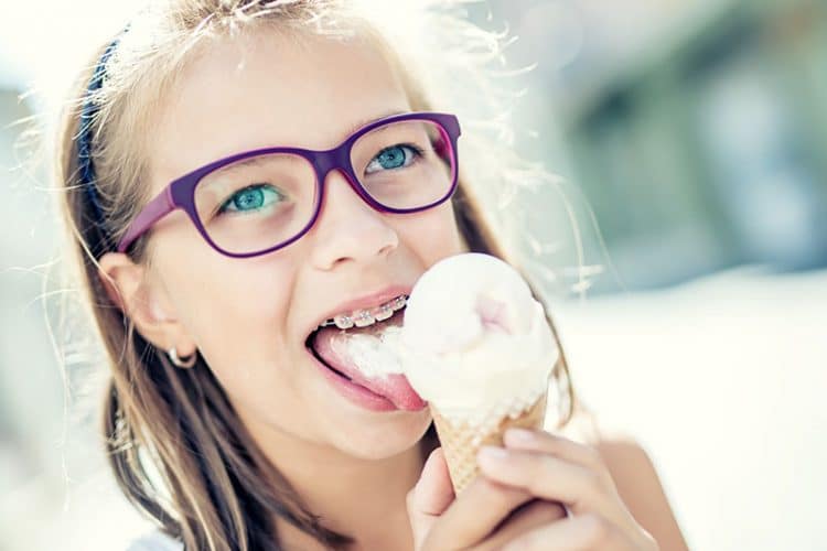 Young girl with braces eating braces-friendly ice cream