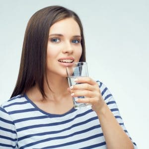 Girl with braces drinking water