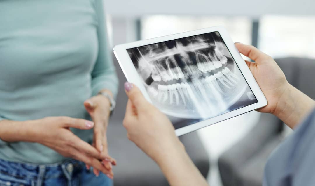 Two people with an Ipad showing a jaw xray